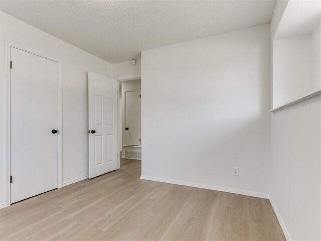 7017 S Miller Ave, Oklahoma City, OK 73159 - unfurnished bedroom featuring light wood-style floors and baseboards