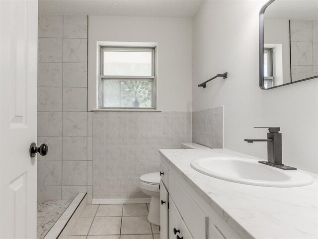 7017 S Miller Ave, Oklahoma City, OK 73159 - bathroom featuring vanity, tile patterned floors, and a tile shower