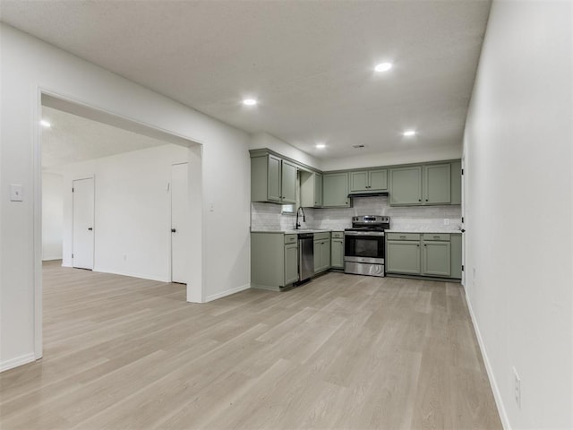 7017 S Miller Ave, Oklahoma City, OK 73159 - kitchen featuring stainless steel appliances, green cabinetry, light wood-style flooring, light countertops, and recessed lighting