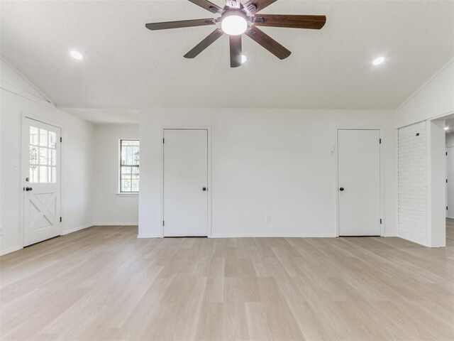 7017 S Miller Ave, Oklahoma City, OK 73159 - unfurnished living room with vaulted ceiling, light wood-style floors, a ceiling fan, and recessed lighting