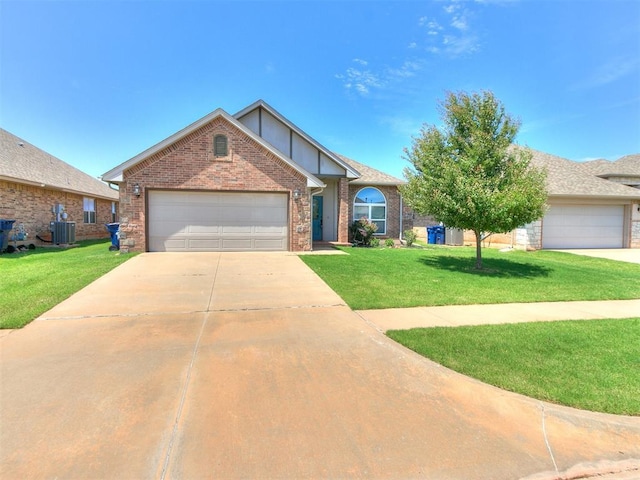 2517 NW 194th St, Edmond, OK 73012 - view of front of property featuring a front yard, brick siding, driveway, and an attached garage
