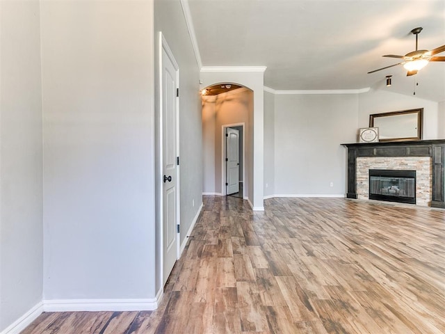 2517 NW 194th St, Edmond, OK 73012 - unfurnished living room with a ceiling fan, wood finished floors, a stone fireplace, crown molding, and vaulted ceiling