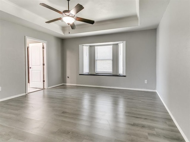 2517 NW 194th St, Edmond, OK 73012 - spare room featuring a tray ceiling, crown molding, wood finished floors, and a ceiling fan