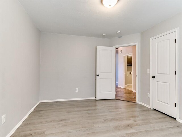 2517 NW 194th St, Edmond, OK 73012 - unfurnished bedroom with light wood-style flooring and baseboards