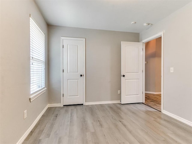 2517 NW 194th St, Edmond, OK 73012 - unfurnished bedroom with light wood-type flooring and multiple windows