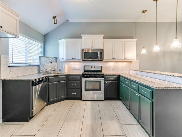 2517 NW 194th St, Edmond, OK 73012 - kitchen with stainless steel appliances, a peninsula, lofted ceiling, white cabinetry, and tasteful backsplash
