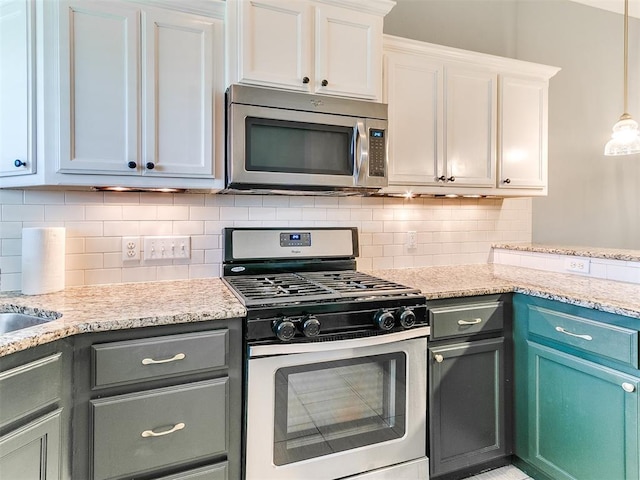 2517 NW 194th St, Edmond, OK 73012 - kitchen with stainless steel appliances, backsplash, white cabinetry, and light stone countertops