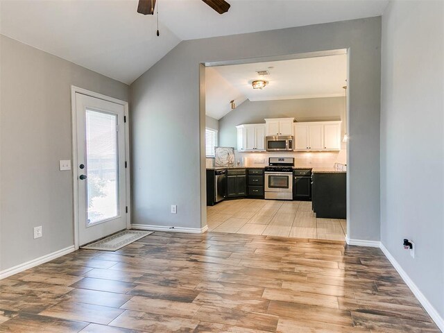 2517 NW 194th St, Edmond, OK 73012 - kitchen with appliances with stainless steel finishes, lofted ceiling, white cabinets, light wood-type flooring, and ceiling fan