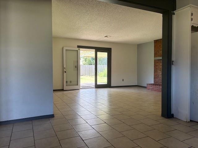 5720 Rushing Rd, Oklahoma City, OK 73132 - empty room with a textured ceiling and light tile patterned floors