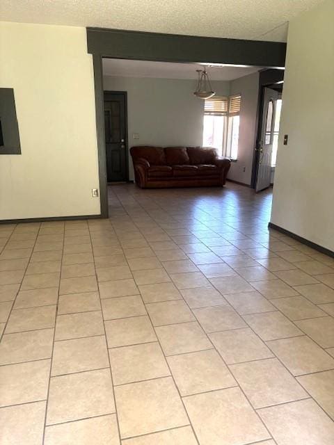 5720 Rushing Rd, Oklahoma City, OK 73132 - living area featuring a textured ceiling and light tile patterned floors