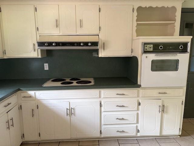 5720 Rushing Rd, Oklahoma City, OK 73132 - kitchen featuring white appliances, exhaust hood, white cabinetry, and light tile patterned floors