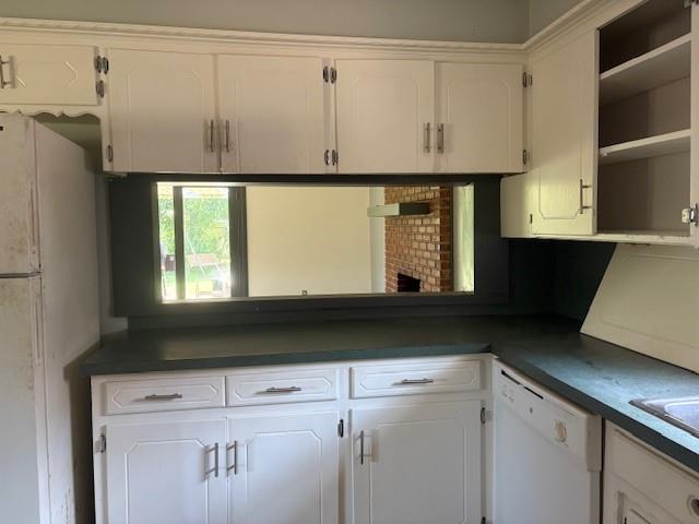 5720 Rushing Rd, Oklahoma City, OK 73132 - kitchen with white appliances, dark countertops, open shelves, and white cabinets