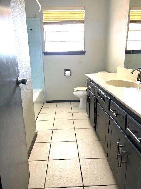 5720 Rushing Rd, Oklahoma City, OK 73132 - bathroom with vanity, plenty of natural light, tile patterned floors, and washtub / shower combination