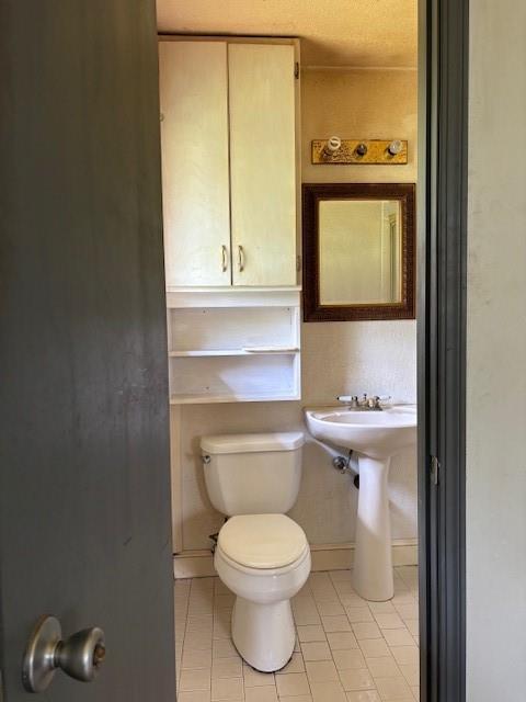 5720 Rushing Rd, Oklahoma City, OK 73132 - bathroom featuring tile patterned floors and toilet
