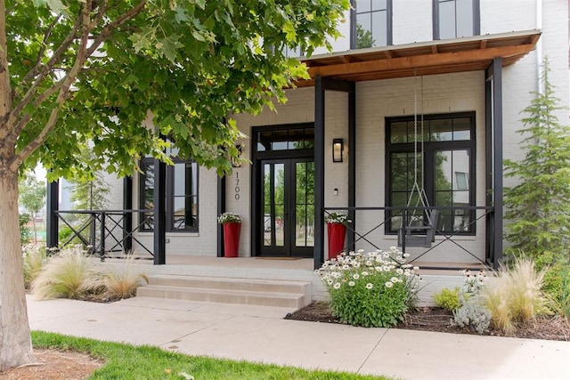 1700 Runway Blvd, Oklahoma City, OK 73108 - entrance to property featuring covered porch, brick siding, and french doors