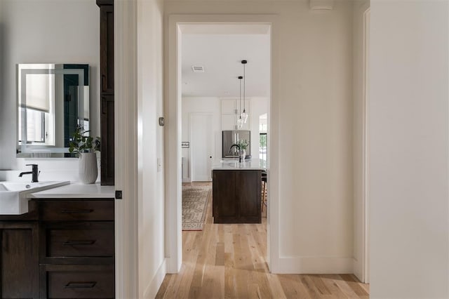 1700 Runway Blvd, Oklahoma City, OK 73108 - hall featuring light wood finished floors and a sink
