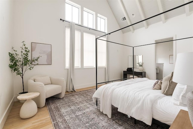 1700 Runway Blvd, Oklahoma City, OK 73108 - bedroom featuring high vaulted ceiling, light wood-style floors, and beam ceiling