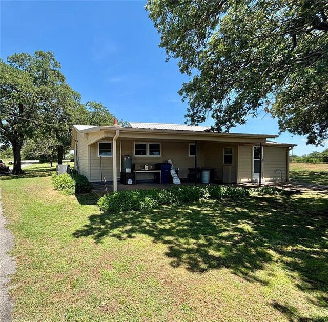 5311 S Cason Rd, Marlow, OK 73055 - rear view of house featuring a yard and metal roof