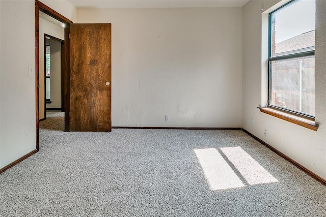 1405 Creston Way, Edmond, OK 73012 - empty room featuring carpet flooring and healthy amount of natural light