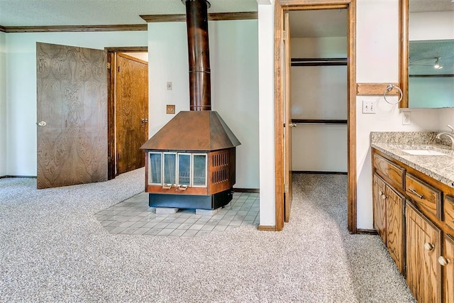 1405 Creston Way, Edmond, OK 73012 - bathroom with a wood stove, vanity, ornamental molding, and carpet flooring