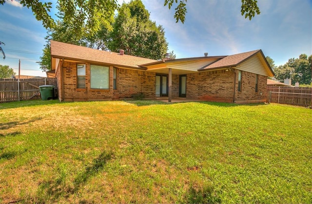 1405 Creston Way, Edmond, OK 73012 - rear view of house with brick siding and a fenced backyard