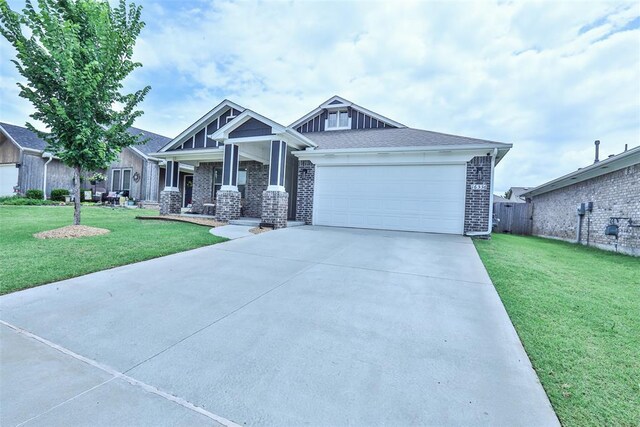 16336 Coldfire Rd, Oklahoma City, OK 73170 - craftsman house with brick siding, driveway, a front yard, and a garage