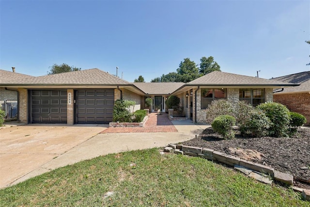 2617 NW 58th St, Oklahoma City, OK 73112 - ranch-style home with a garage, driveway, and brick siding