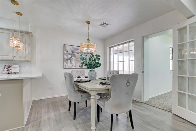 2617 NW 58th St, Oklahoma City, OK 73112 - dining room with a chandelier and light wood-style floors