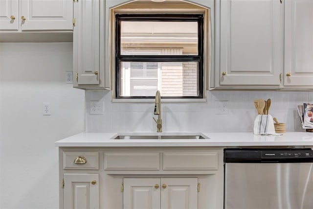2617 NW 58th St, Oklahoma City, OK 73112 - kitchen with dishwasher, light countertops, tasteful backsplash, and white cabinetry