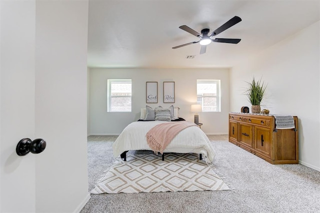 2617 NW 58th St, Oklahoma City, OK 73112 - carpeted bedroom with multiple windows and a ceiling fan