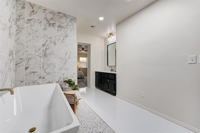 2617 NW 58th St, Oklahoma City, OK 73112 - full bathroom with a freestanding tub, ensuite bathroom, vanity, and recessed lighting
