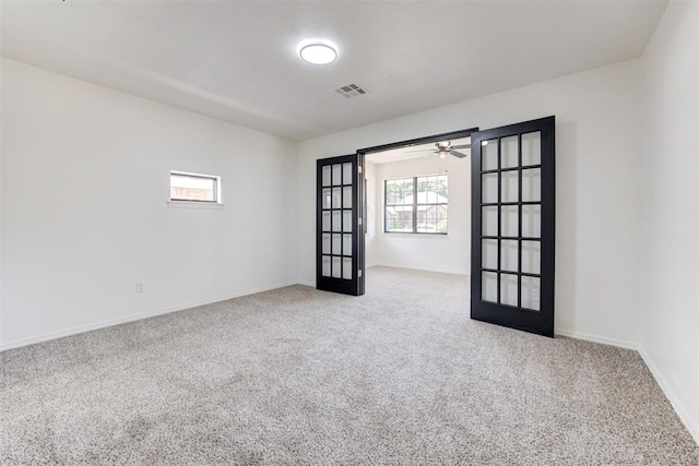 2617 NW 58th St, Oklahoma City, OK 73112 - carpeted spare room featuring french doors and a ceiling fan