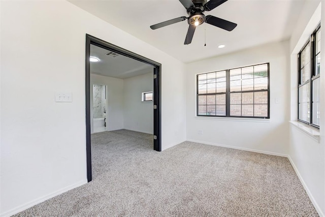2617 NW 58th St, Oklahoma City, OK 73112 - carpeted empty room featuring healthy amount of natural light and a ceiling fan
