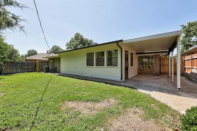 2617 NW 58th St, Oklahoma City, OK 73112 - rear view of house featuring a fenced backyard, a patio area, and brick siding