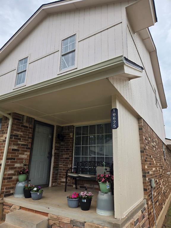 10625 White Oak Canyon Rd, Oklahoma City, OK 73162 - property entrance featuring brick siding and covered porch