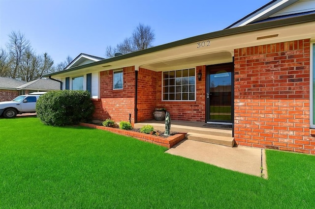302 Tanglewood Dr, Yukon, OK 73099 - entrance to property with brick siding and a lawn