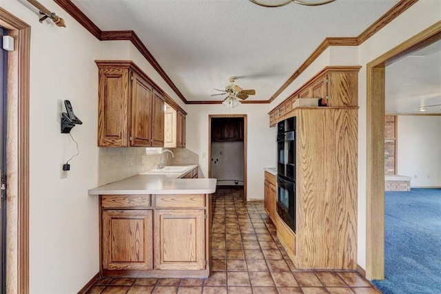 302 Tanglewood Dr, Yukon, OK 73099 - kitchen featuring a ceiling fan, crown molding, light countertops, a peninsula, and tasteful backsplash