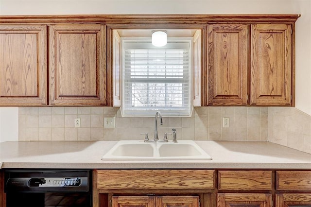 302 Tanglewood Dr, Yukon, OK 73099 - kitchen with dishwasher, light countertops, and brown cabinetry