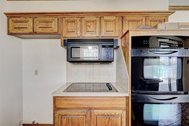 302 Tanglewood Dr, Yukon, OK 73099 - kitchen featuring black appliances, decorative backsplash, light countertops, and brown cabinetry