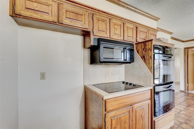 302 Tanglewood Dr, Yukon, OK 73099 - kitchen featuring black appliances, light countertops, backsplash, crown molding, and a textured ceiling