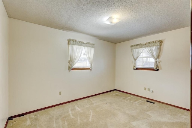 302 Tanglewood Dr, Yukon, OK 73099 - carpeted spare room with plenty of natural light and a textured ceiling