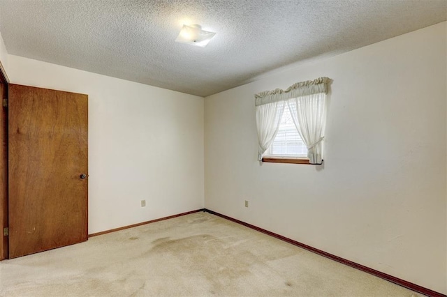302 Tanglewood Dr, Yukon, OK 73099 - carpeted empty room featuring a textured ceiling and baseboards