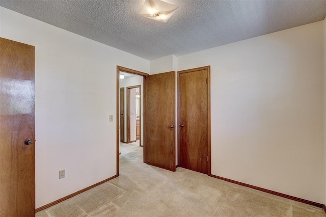 302 Tanglewood Dr, Yukon, OK 73099 - unfurnished bedroom with light carpet, a textured ceiling, and a closet