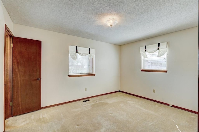 302 Tanglewood Dr, Yukon, OK 73099 - unfurnished room with carpet floors and a textured ceiling