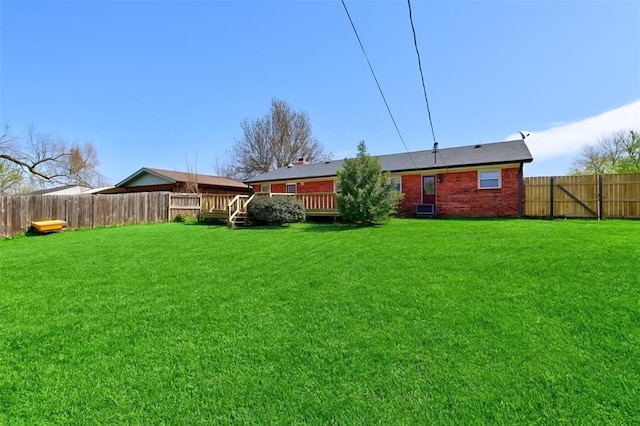 302 Tanglewood Dr, Yukon, OK 73099 - back of house featuring a fenced backyard, a deck, and brick siding