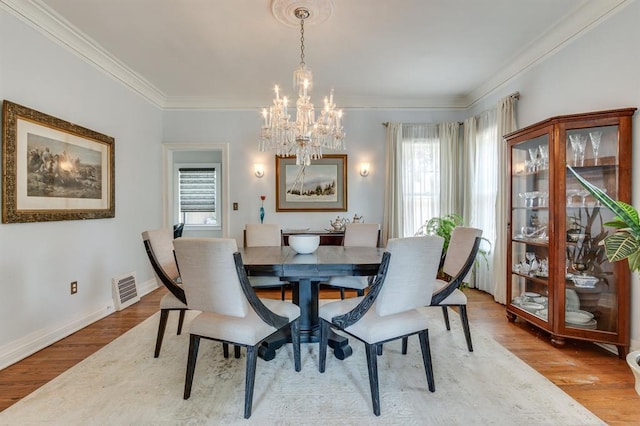 707 NE 18th St, Oklahoma City, OK 73105 - dining area with a chandelier, plenty of natural light, crown molding, and wood finished floors