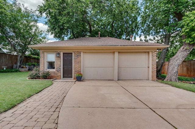 707 NE 18th St, Oklahoma City, OK 73105 - view of front facade featuring brick siding, driveway, and a garage