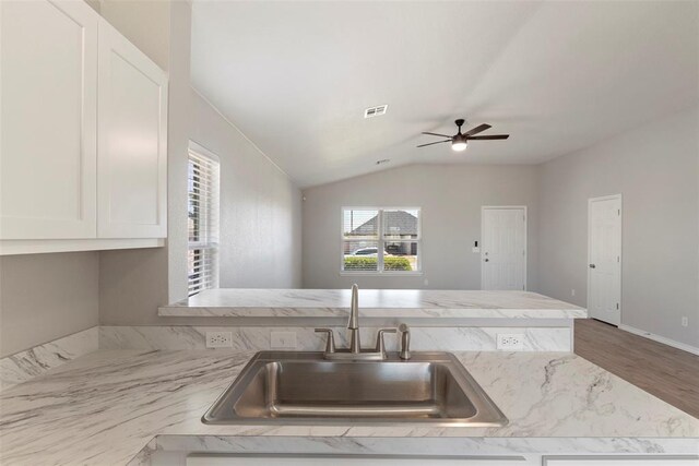 1908 E View Dr, Norman, OK 73071 - kitchen featuring vaulted ceiling, ceiling fan, wood finished floors, white cabinets, and a peninsula