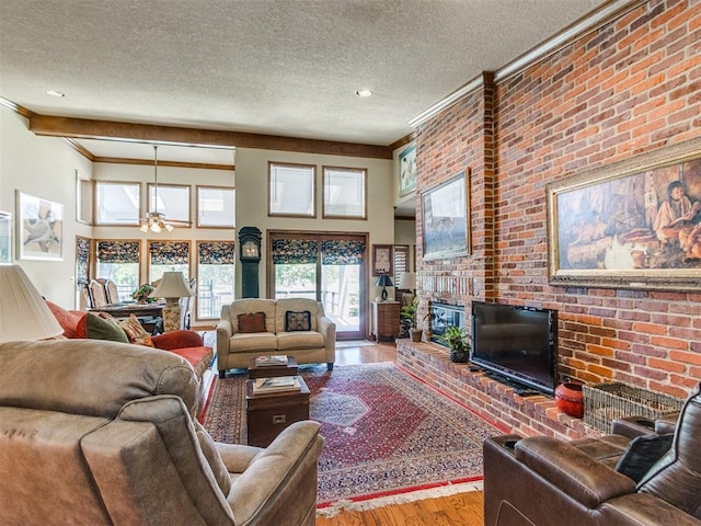 9 Country Club Rd, Shawnee, OK 74801 - living room featuring a fireplace, wood finished floors, a textured ceiling, ornamental molding, and a ceiling fan