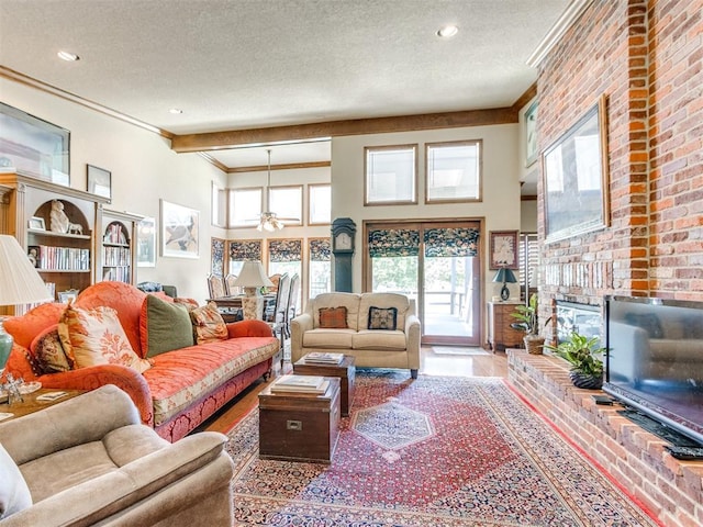 9 Country Club Rd, Shawnee, OK 74801 - living room with crown molding, a textured ceiling, a brick fireplace, a ceiling fan, and a towering ceiling